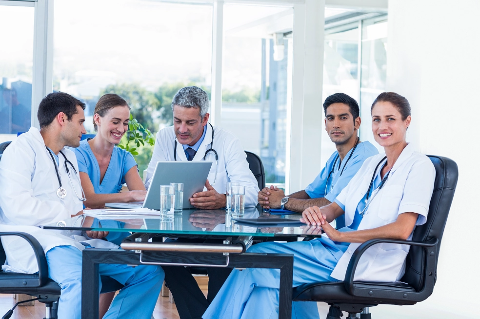 Group of nurses and doctors sitting together and discussing