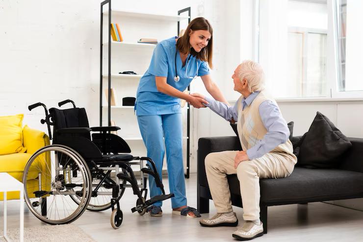 Female nurse assisting a male patient in a wheelchair