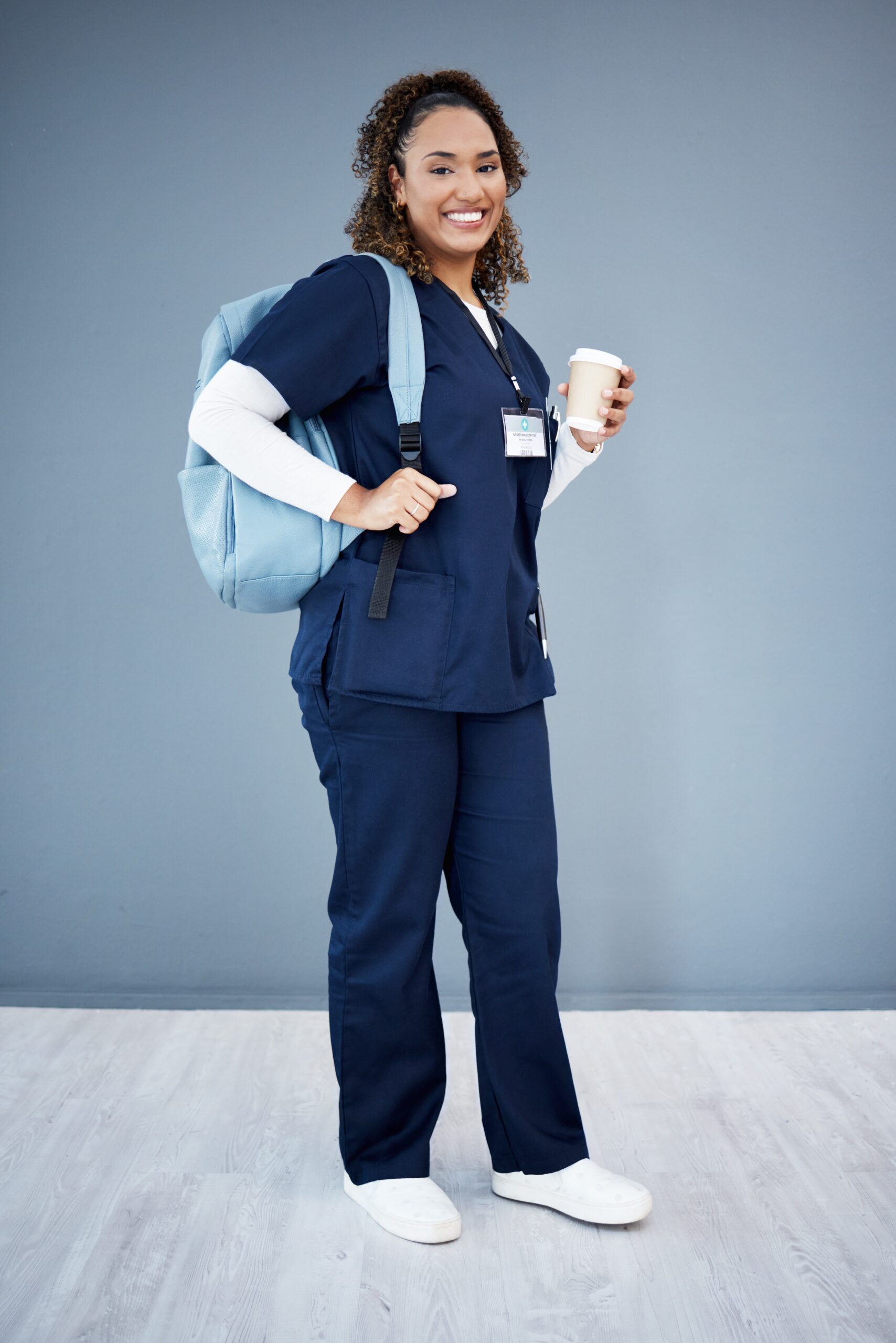 Smiling nursing student with a bag at Chancellor Institute